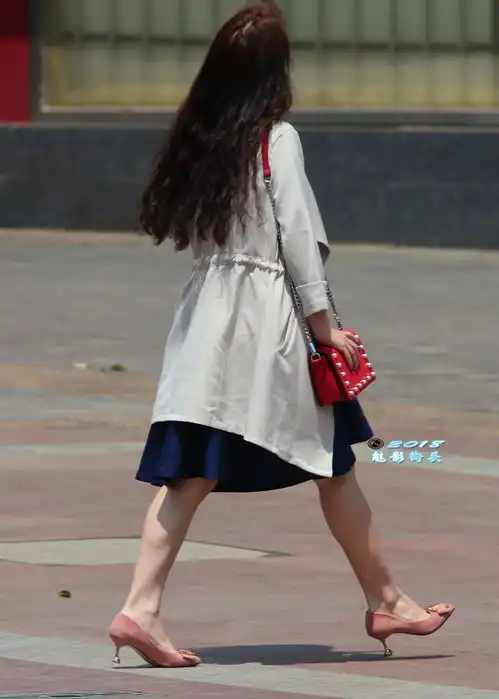 穿风衣蓝色连衣裙的美女迈着自信的步伐,自信的女人最漂亮